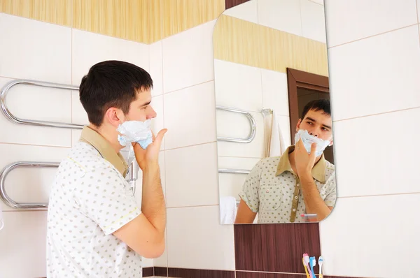 Young man shaving in the morning — Stock Photo, Image
