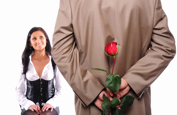 Young man gives his girlfriend a rose — Stock Photo, Image