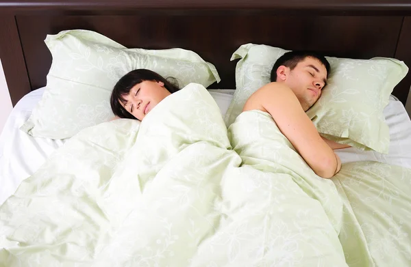 つのベッドで一緒に寝ている若いカップル — ストック写真