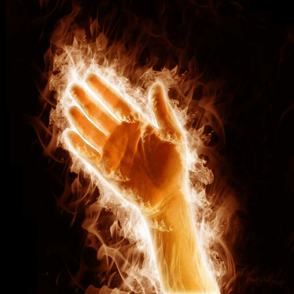 Human hand open arms fire on a black background