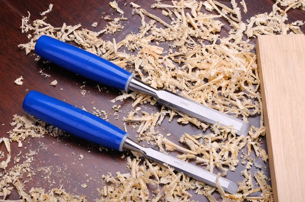Two Bits Blue Background Wood Shavings Royalty Free Stock Photos