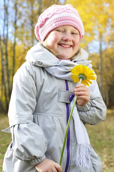 Little girl with a yellow flower — Stock Photo, Image