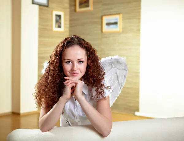 Young Red Hair Woman Angel Wings Sitting Sofa — 스톡 사진