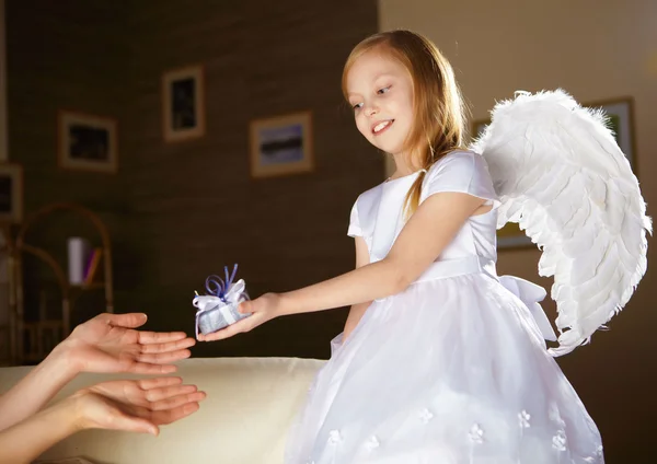 Girl in white dressed as an angel Stock Photo
