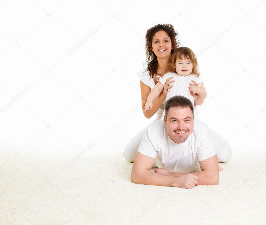 Portrait of mother, father and their child together in studio