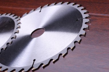 The metal disc is a circular saw on a dark background clipart