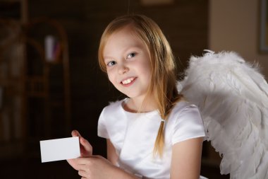 A little girl in white dress with angel's wings clipart
