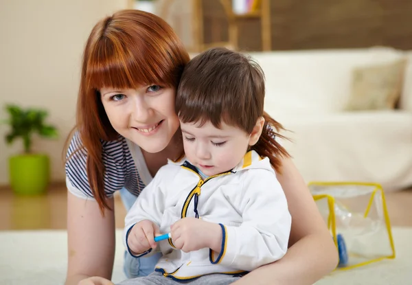 Young mother playing with her little son — Stock Photo, Image