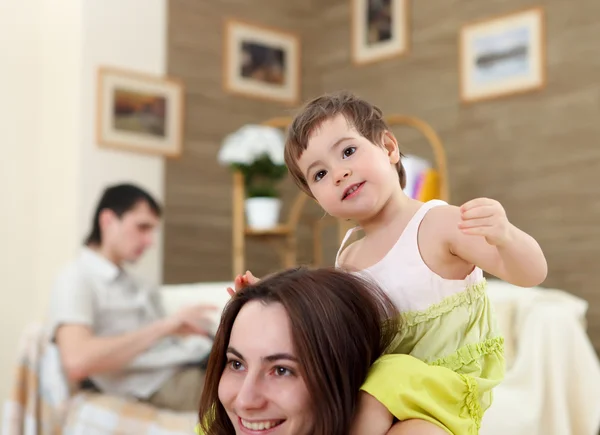 Young mother playing with her baby at home — Stock Photo, Image