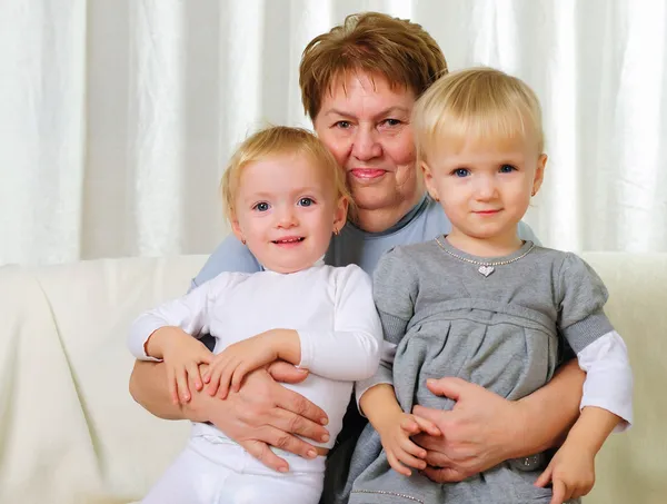 Two twins sisters with their grandmother — Stock Photo, Image