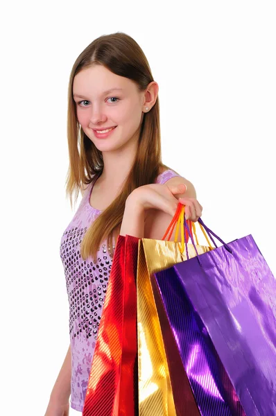 Jong meisje met boodschappentassen — Stockfoto