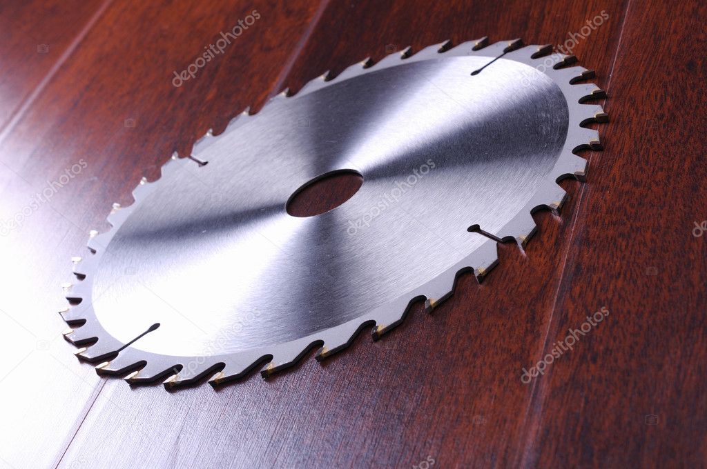 The metal disc is a circular saw on a dark background