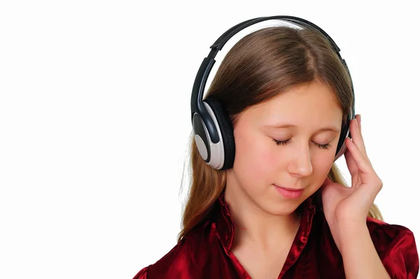 Uma adolescente no estúdio com fones de ouvido — Fotografia de Stock