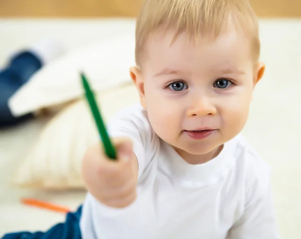 Маленький хлопчик малює кольоровими олівцями — стокове фото