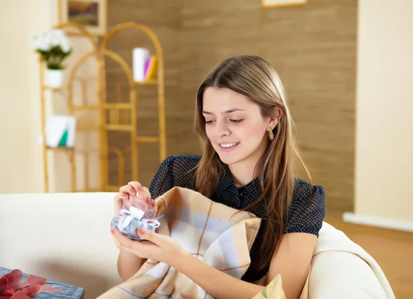 Young woman with present at home — Stock Photo, Image