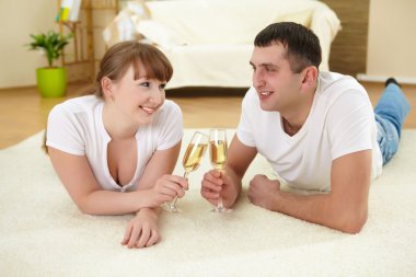 Couple at home drinking champagne clipart