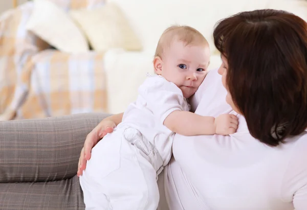 stock image A young mother with her infant baby at home