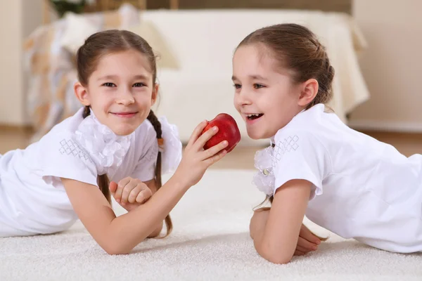 Stock image Twin sisters together at home