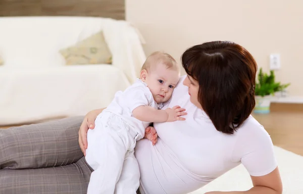 stock image A young mother with her infant baby at home