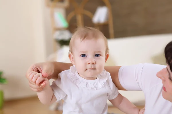 stock image A young mother with her infant baby at home