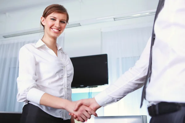 Handshake by a business woman — Stock Photo, Image
