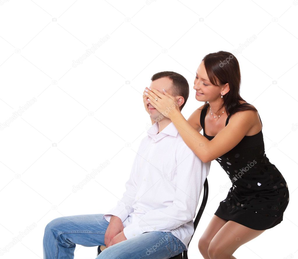 Girlfriend closing eyes of her boyfriend