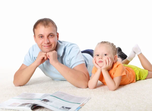 Young father reading a book to his daughter — Stock Photo, Image