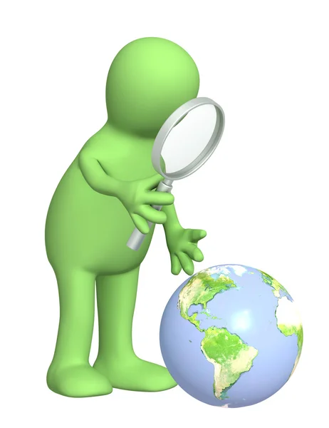 Puppet with a magnifier and Earth — Stock Photo, Image
