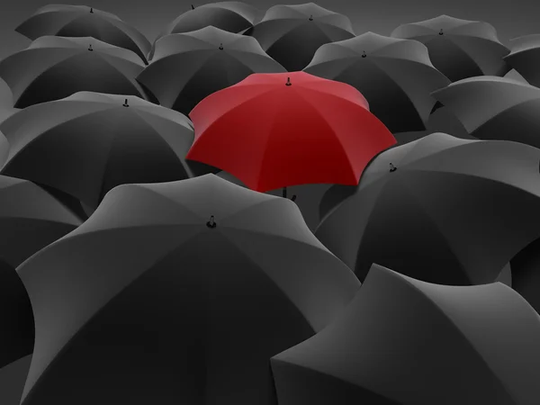 Ein roter Regenschirm neben anderen schwarzen — Stockfoto