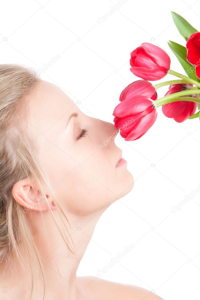 Woman smells bunch of flowers