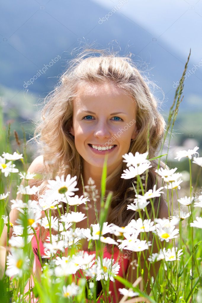 Smiling woman and chamomiles