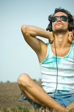 Young man listening to music clipart