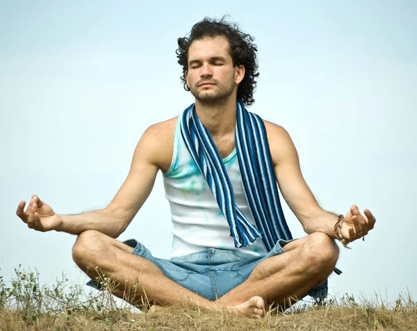 Young man in yoga position — Stock Photo, Image