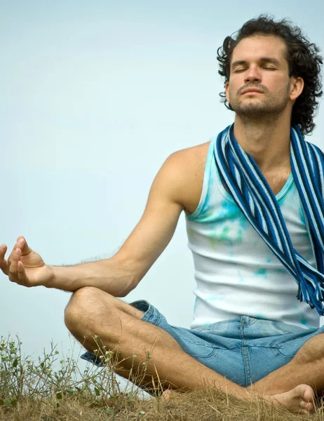 Young man in yoga position — Stock Photo, Image