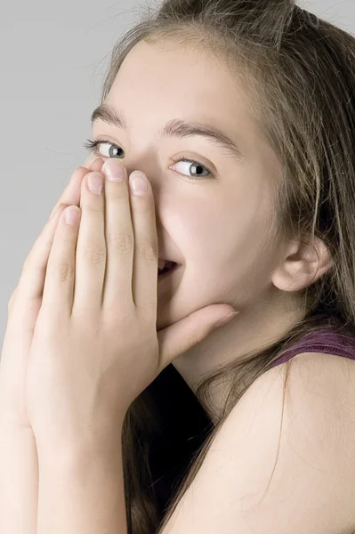 stock image Young girl laughing shielding his face with his hands