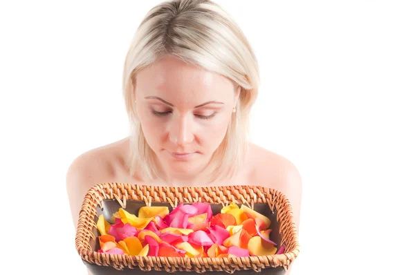 Woman and petals on the plate — Stock Photo, Image