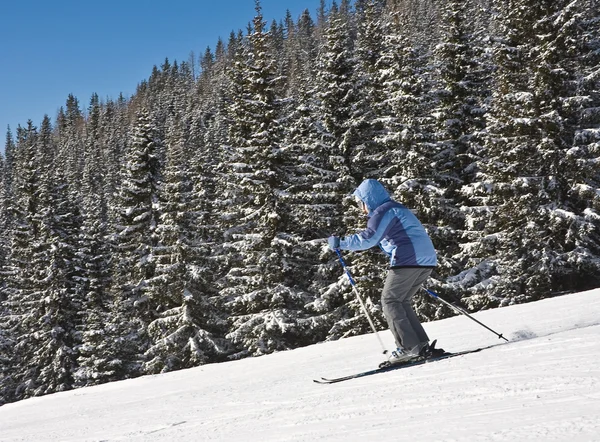 Kobieta jest jazda na nartach w ośrodku narciarskim — Zdjęcie stockowe