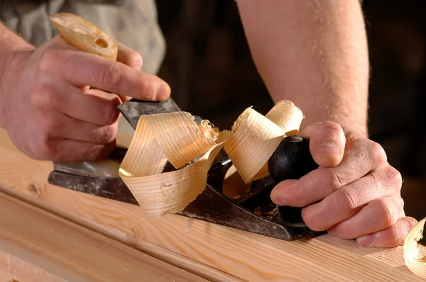 Lavoratore gestisce una tavola di legno un piano — Foto Stock