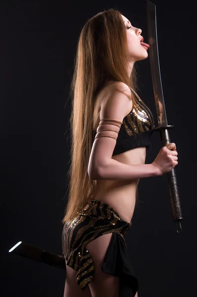 A beautiful woman with a sword — Stock Photo, Image