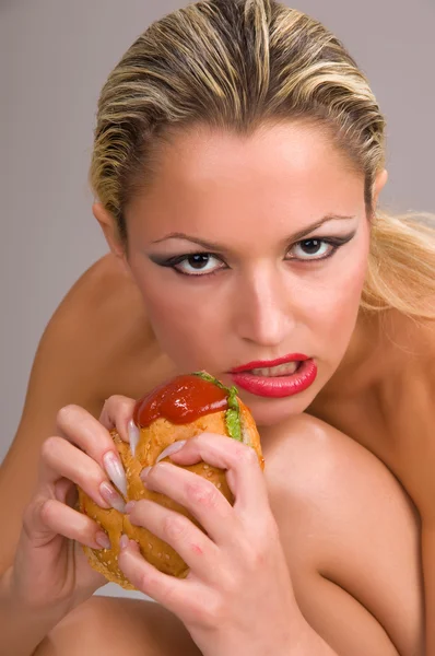 Frau isst einen Hamburger — Stockfoto
