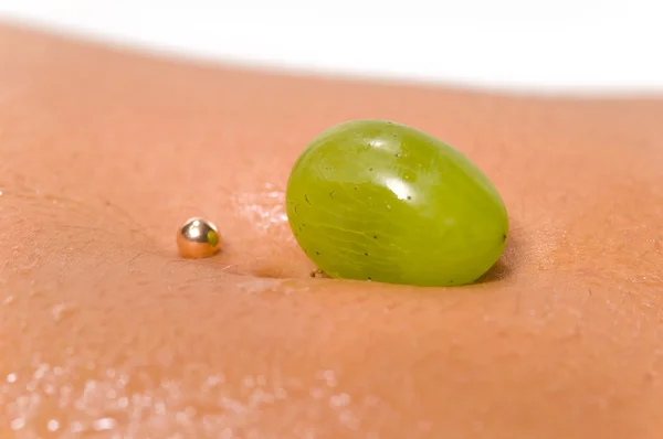 stock image Grapes lying on a woman's body