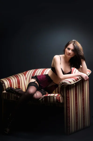 Beautiful brunette on the couch — Stock Photo, Image