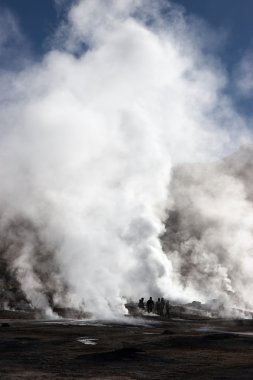 Tourists near erupting geyser, Chile clipart