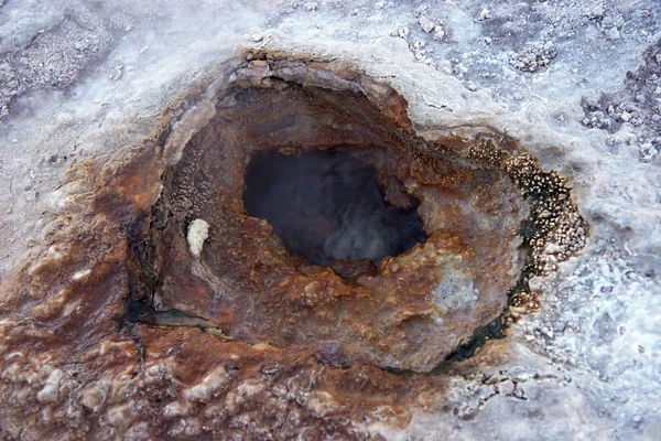 Geyser hole with colored sediments — Stock Photo, Image