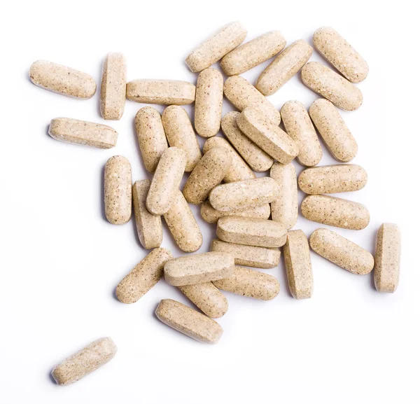 stock image Macro of Beige pills isolated on white b