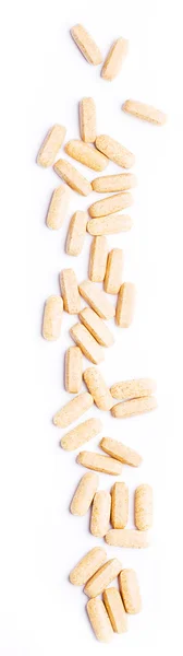 Macro van beige pillen geïsoleerd op witte b — Stockfoto