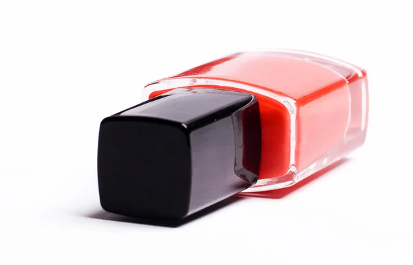 Vertical image of red nail polish on a w — Stock Photo, Image