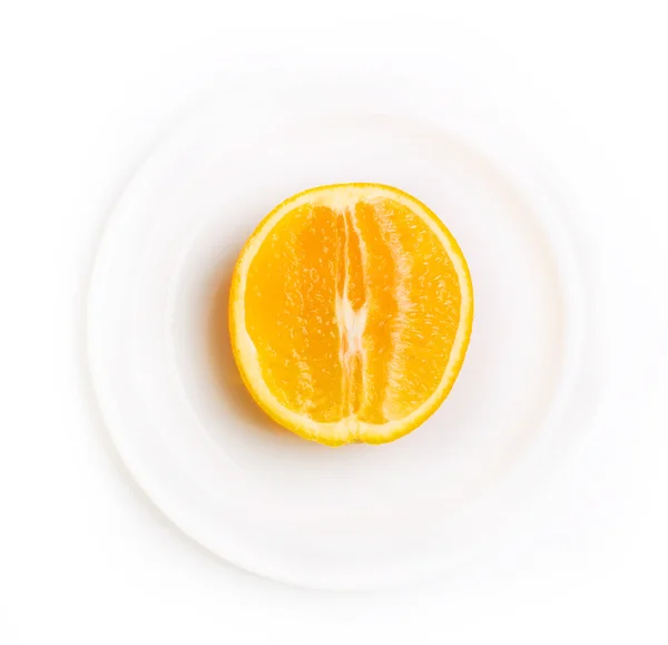 Slice of orange on white plate — Stock Photo, Image