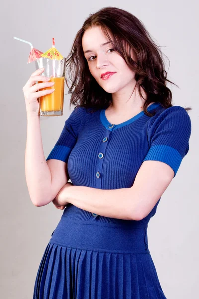 Beauty young woman with orange cocktail — Stock Photo, Image