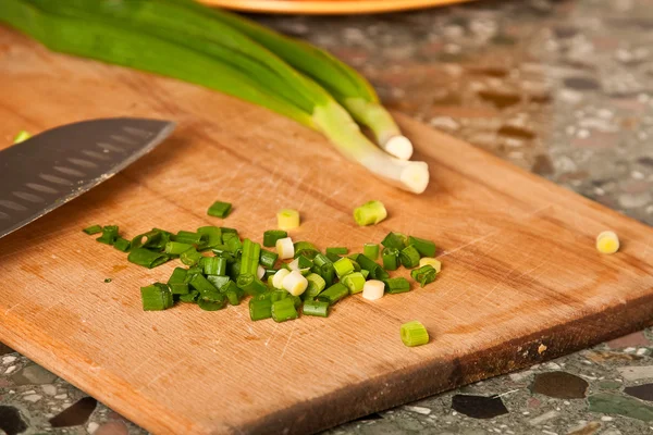 Sliced green onion on a wooden board — Stock Photo, Image